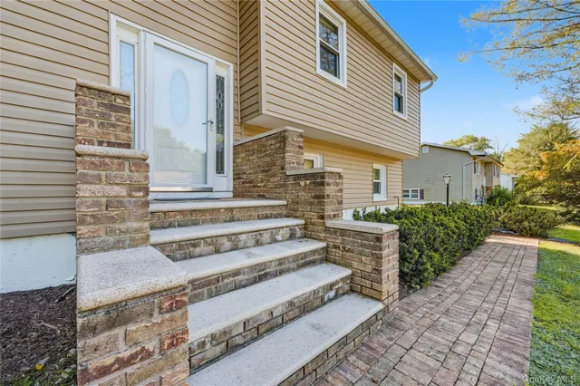 a front view of a house with a garden