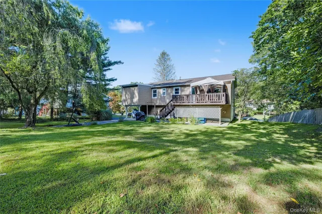 a front view of a house with a yard table and chairs