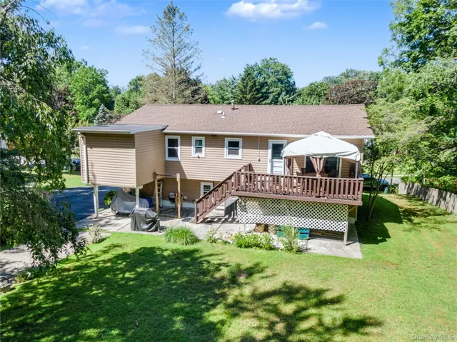 a view of a house with a yard deck and furniture