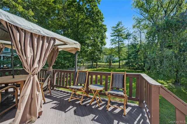 a view of balcony with wooden floor and outdoor seating