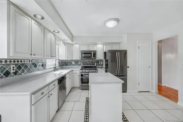 a kitchen with a sink a stove and refrigerator
