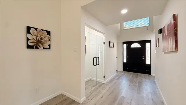 a view of a hallway with wooden floor