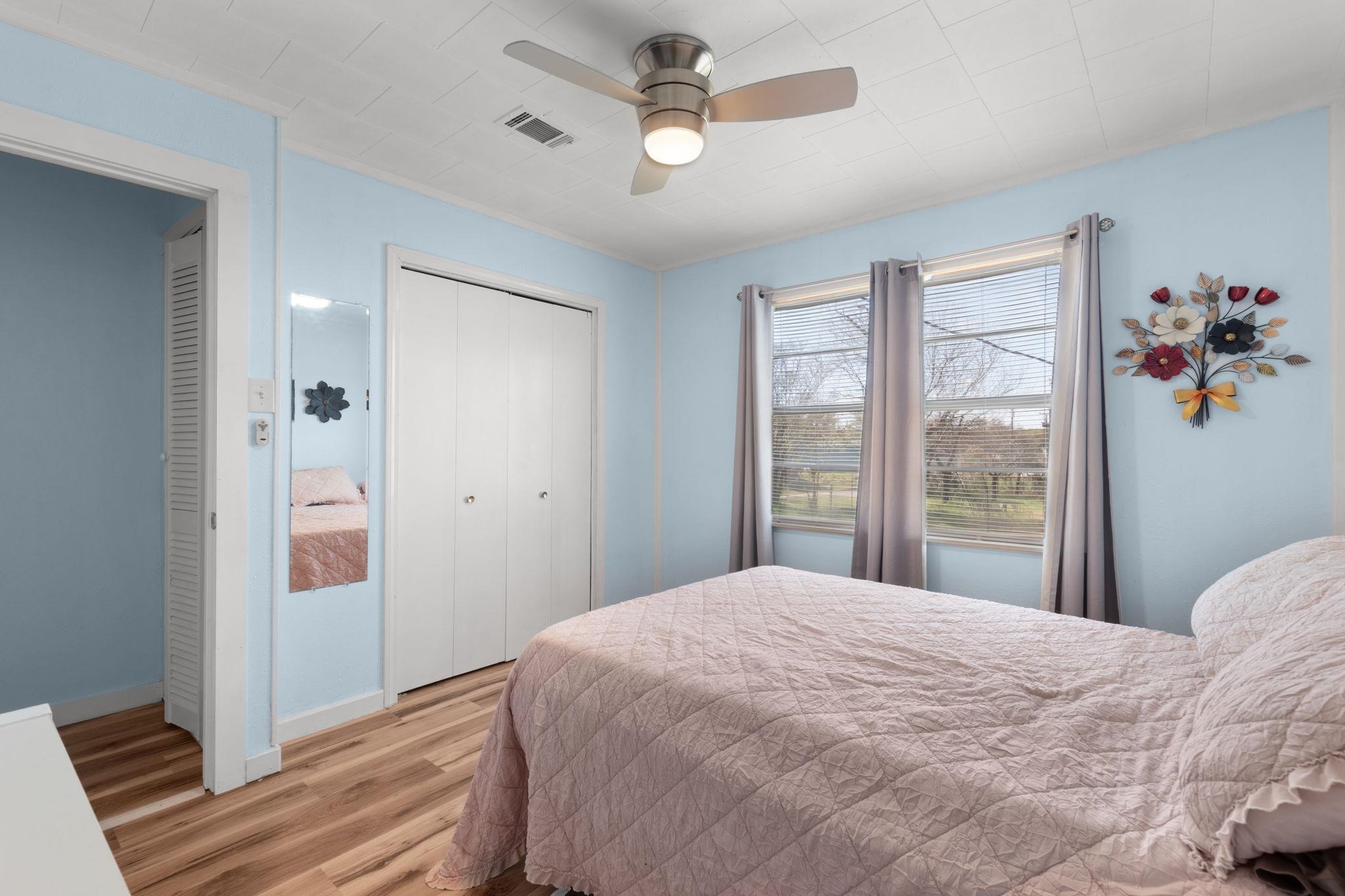 1365 Norma Tow, TX 78672 - Photo 29 of 45 a bedroom with a large bed chandelier and a window