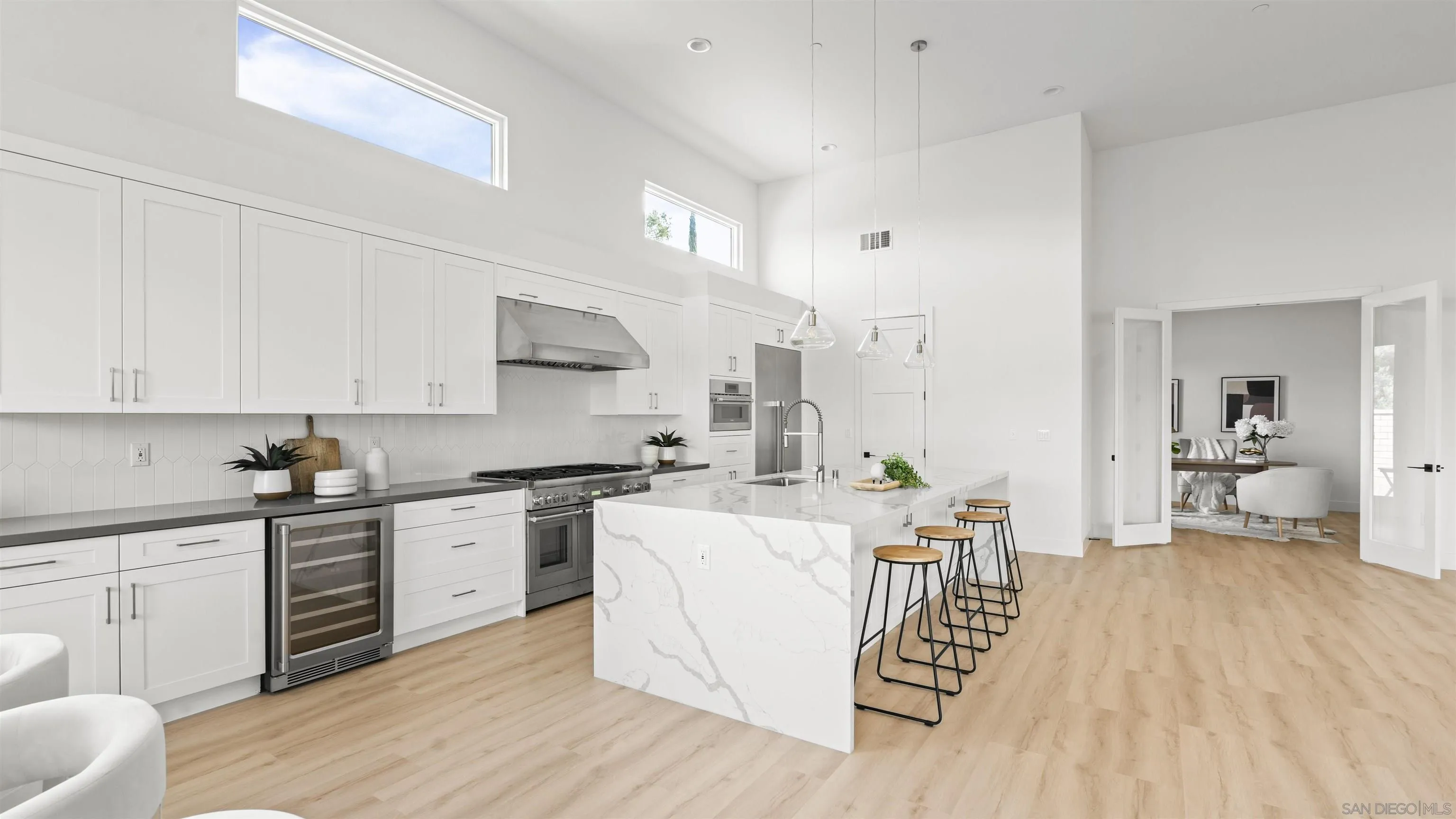 16925 Old Coach Road Poway, CA 92064 - Photo 12 of 53 a large white kitchen with cabinets and wooden floor