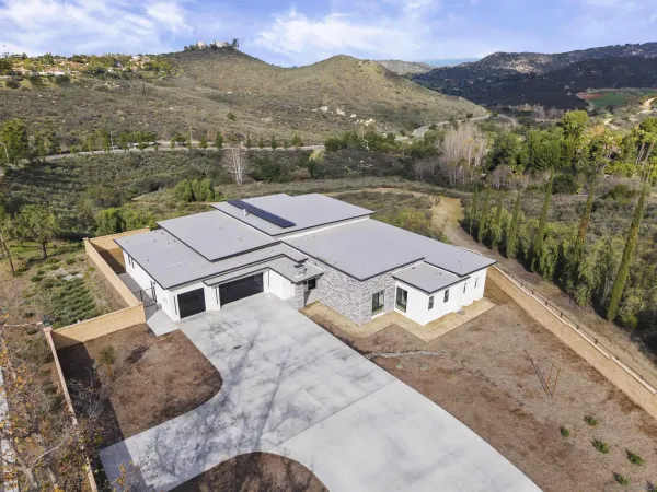 aerial view of a house with a mountain