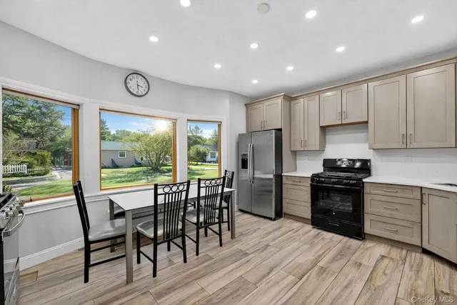 a kitchen with a table chairs refrigerator and cabinets