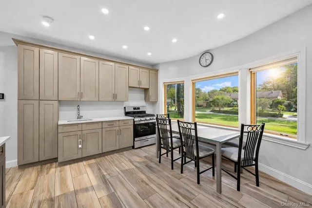 a kitchen with a table chairs sink and cabinets