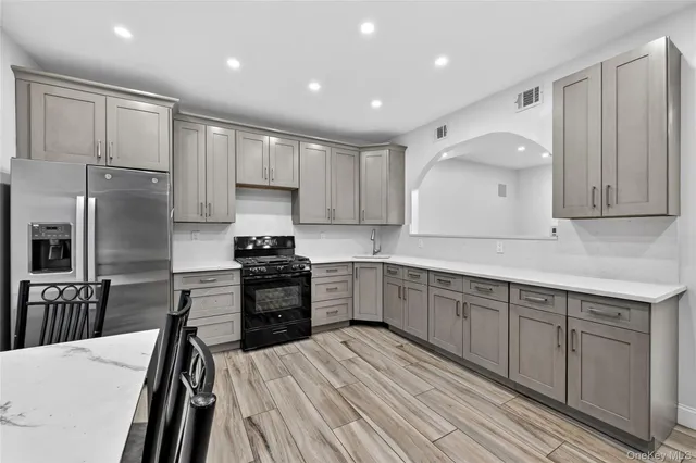 a kitchen with a sink stainless steel appliances and cabinets