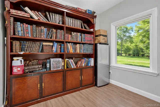 a spacious bedroom with a bed and a chandelier