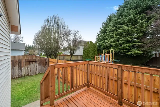 a view of a backyard with wooden fence