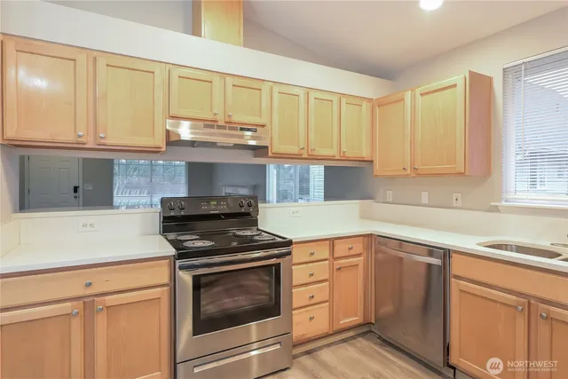 a kitchen with granite countertop white cabinets and appliances