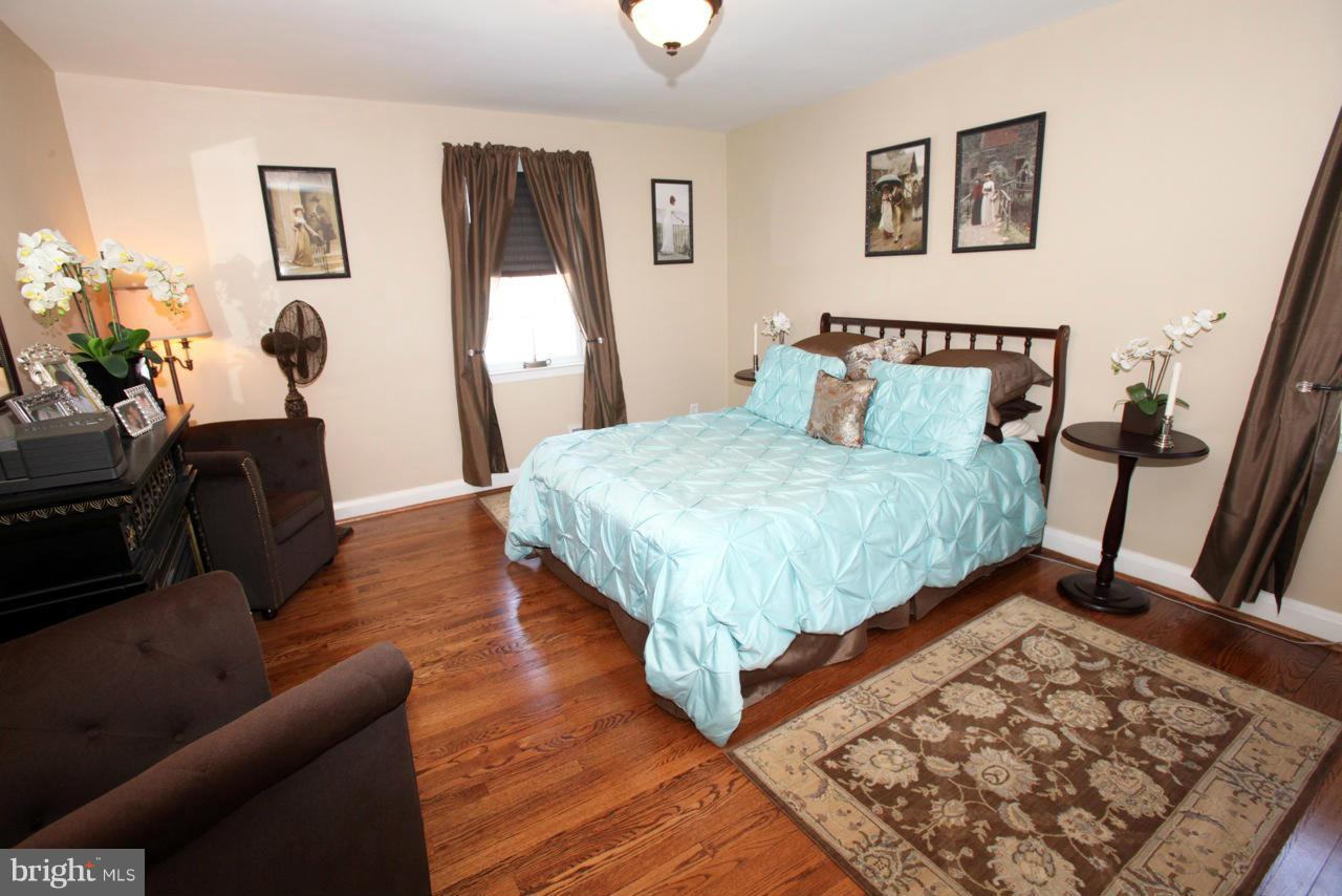 211 Gaywood Road Baltimore, MD 21212 - Photo 14 of 27 a bedroom with a bed and wooden floor