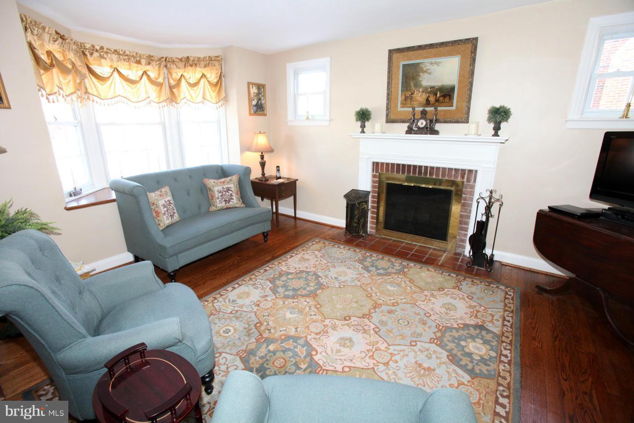 211 Gaywood Road Baltimore, MD 21212 - Photo 3 of 27 a living room with furniture and a fireplace