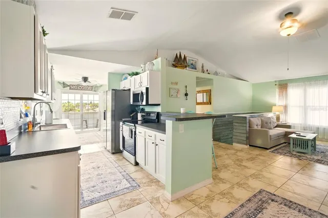 a kitchen with sink cabinets and outdoor view