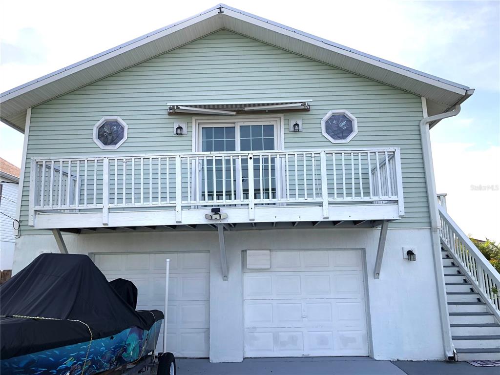 3312 Holly Springs Drive Hernando Beach, FL 34607 - Photo 2 of 42 a front view of a house with balcony