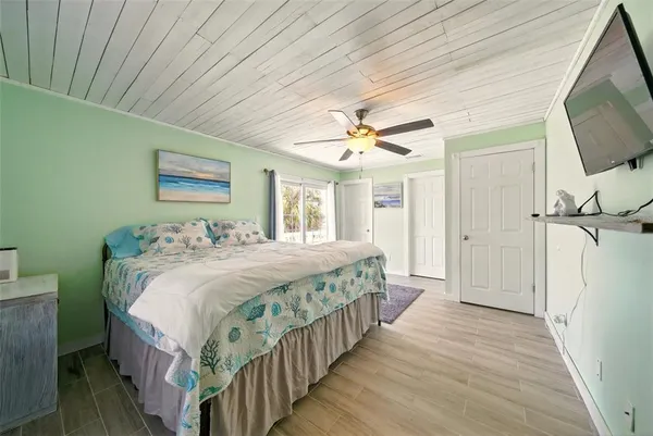 a bedroom with a bed and a flat screen tv