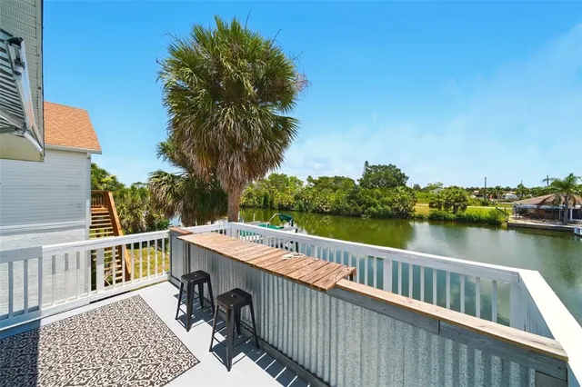 a view of a roof deck with chair and lake view