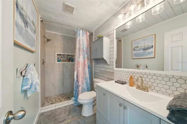 a bathroom with a sink toilet and shower