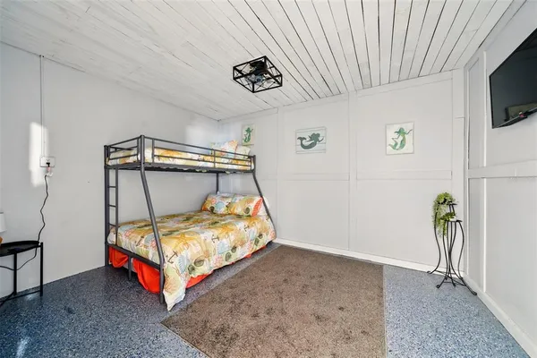 a bedroom with a bed and a tv