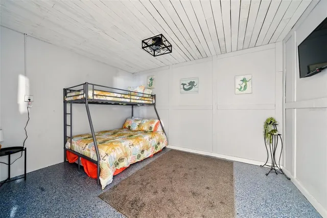 a bedroom with a bed and a tv