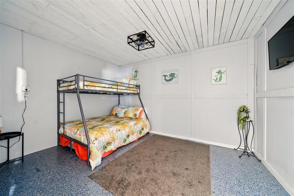 3312 Holly Springs Drive Hernando Beach, FL 34607 - Photo 38 of 42 a bedroom with a bed and a tv