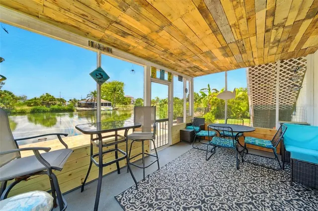 a view of a chairs and table in patio with a backyard
