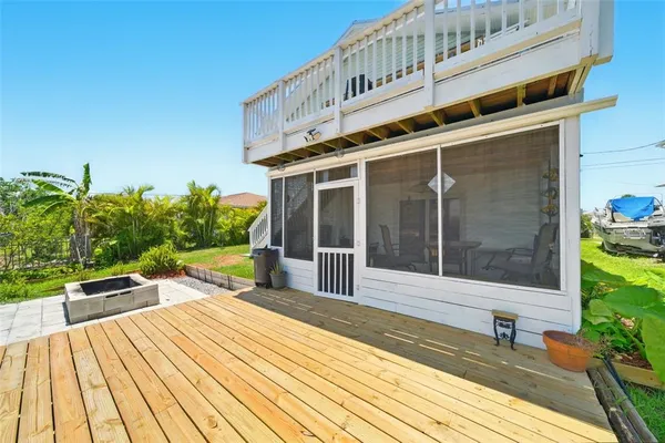 a view of a house with barbeque and sitting area