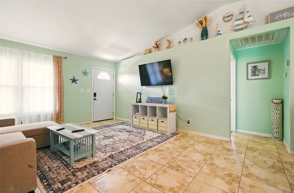 3312 Holly Springs Drive Hernando Beach, FL 34607 - Photo 9 of 42 a living room with furniture and a flat screen tv