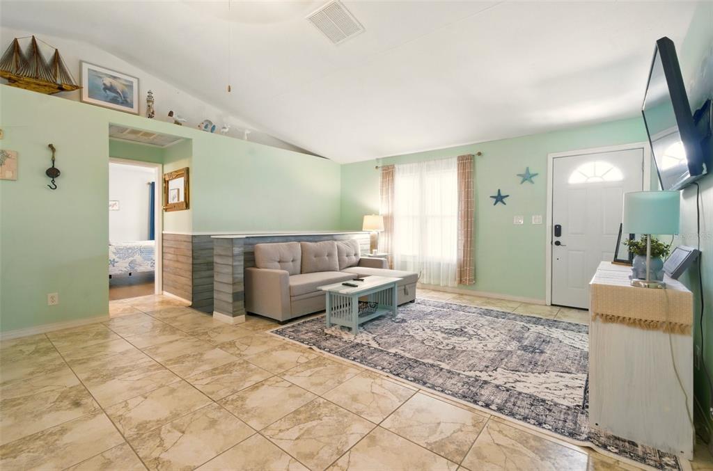 3312 Holly Springs Drive Hernando Beach, FL 34607 - Photo 10 of 42 a living room with furniture and a table