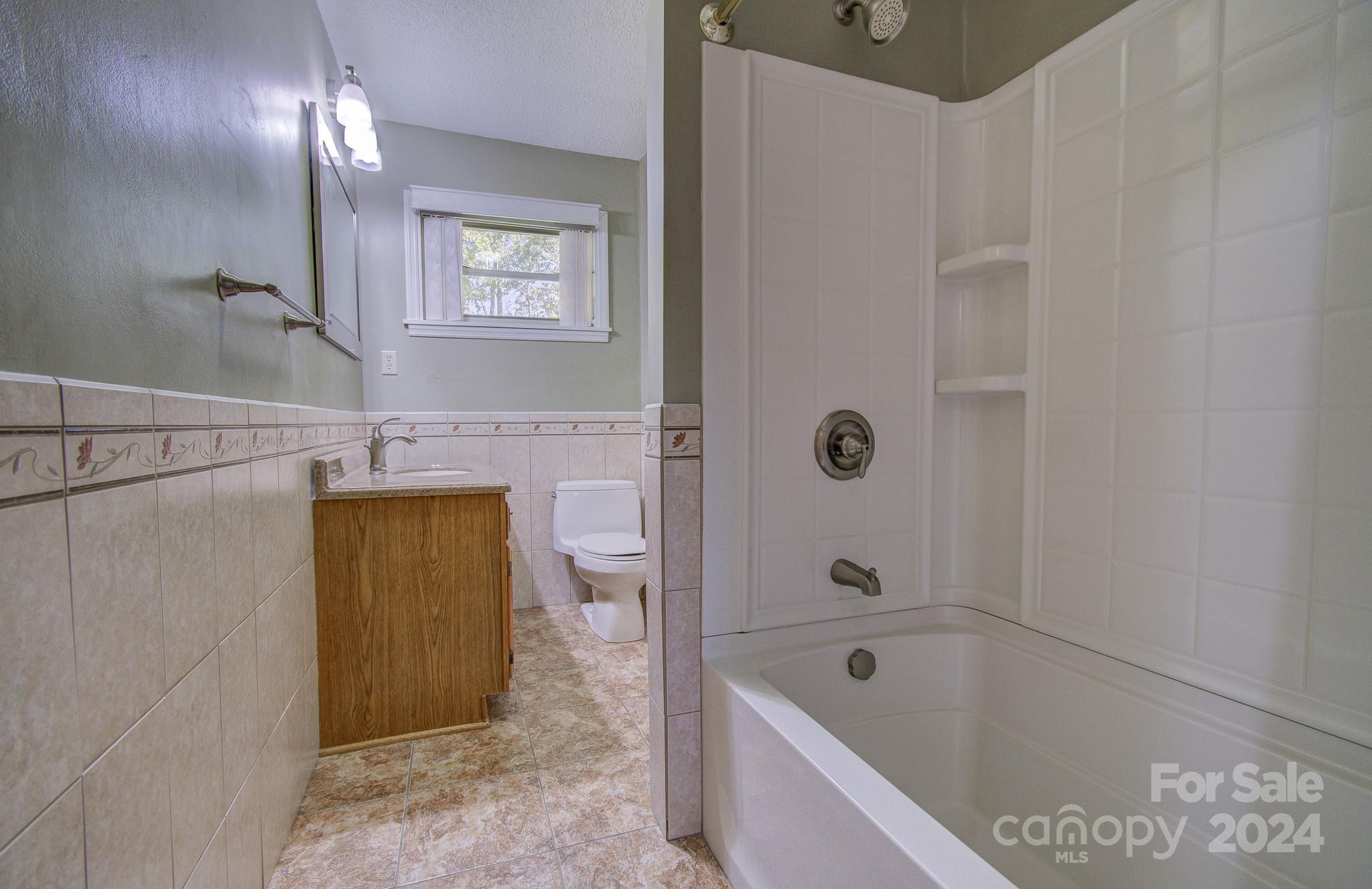 111 Souther Road Fletcher, NC 28732 - Photo 13 of 31 a bathroom with a tub shower and sink
