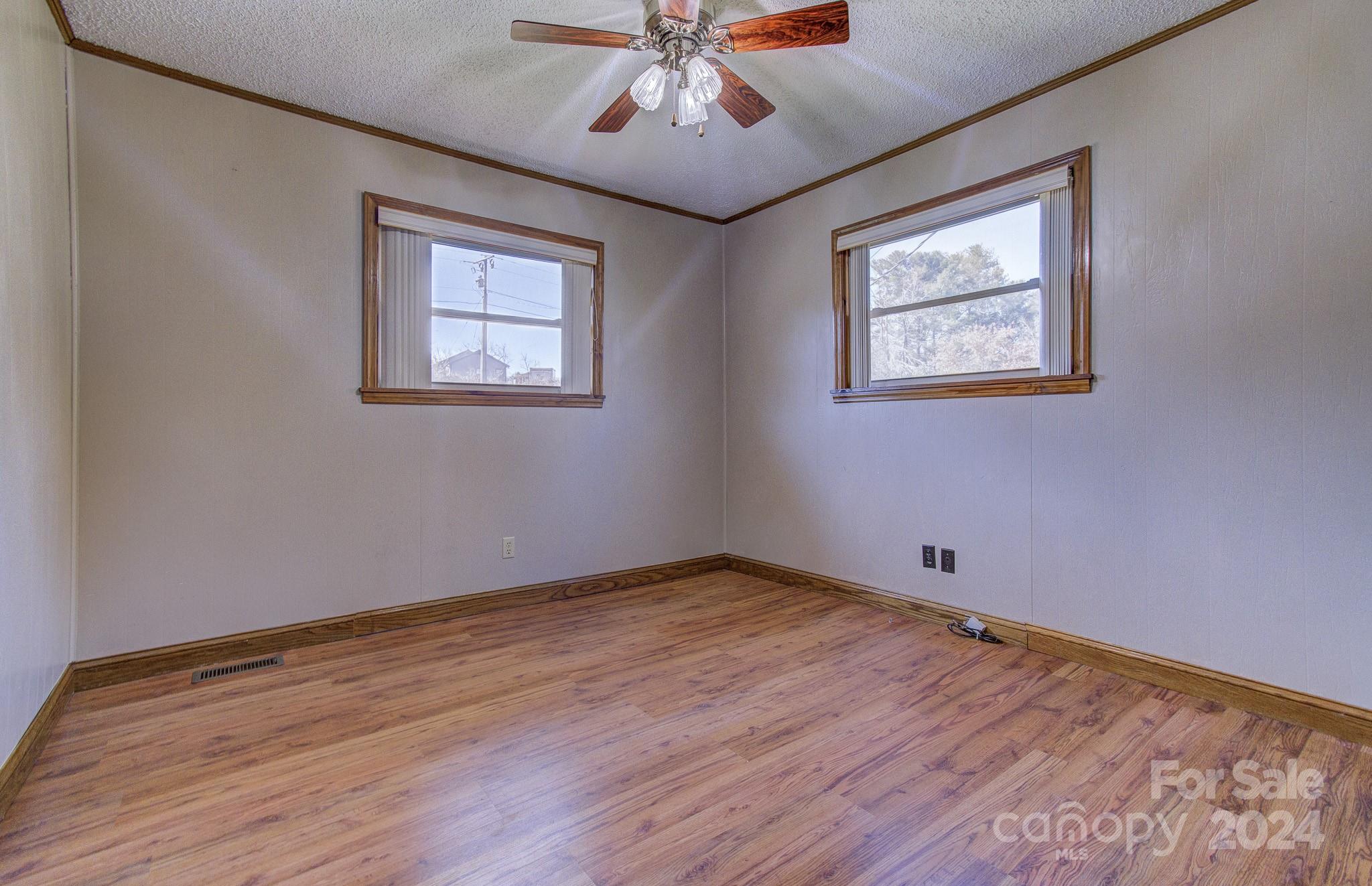 111 Souther Road Fletcher, NC 28732 - Photo 15 of 31 a view of an empty room with wooden floor and a ceiling fan