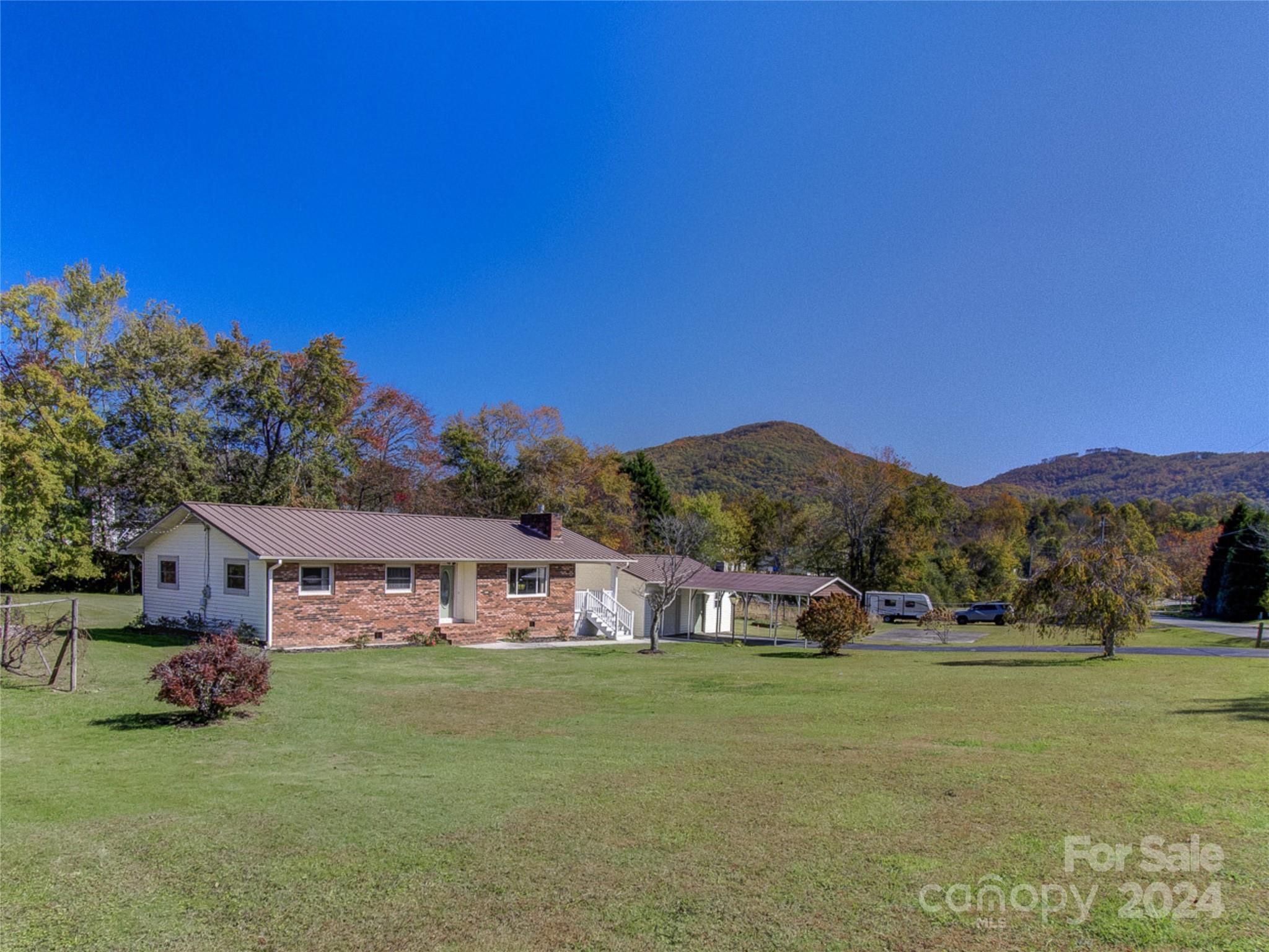 111 Souther Road Fletcher, NC 28732 - Photo 2 of 31 a front view of a house with a garden and yard