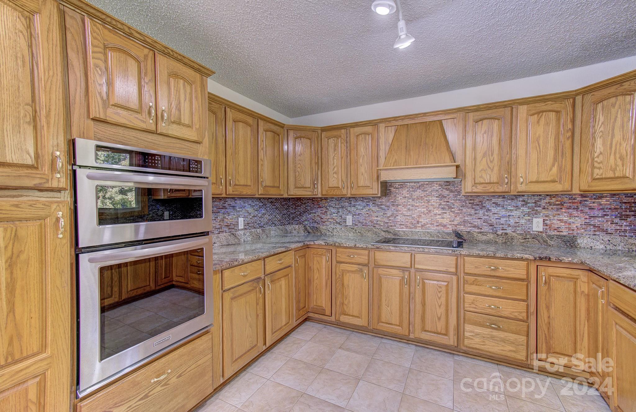 111 Souther Road Fletcher, NC 28732 - Photo 6 of 31 a kitchen with stainless steel appliances granite countertop a stove microwave and cabinets