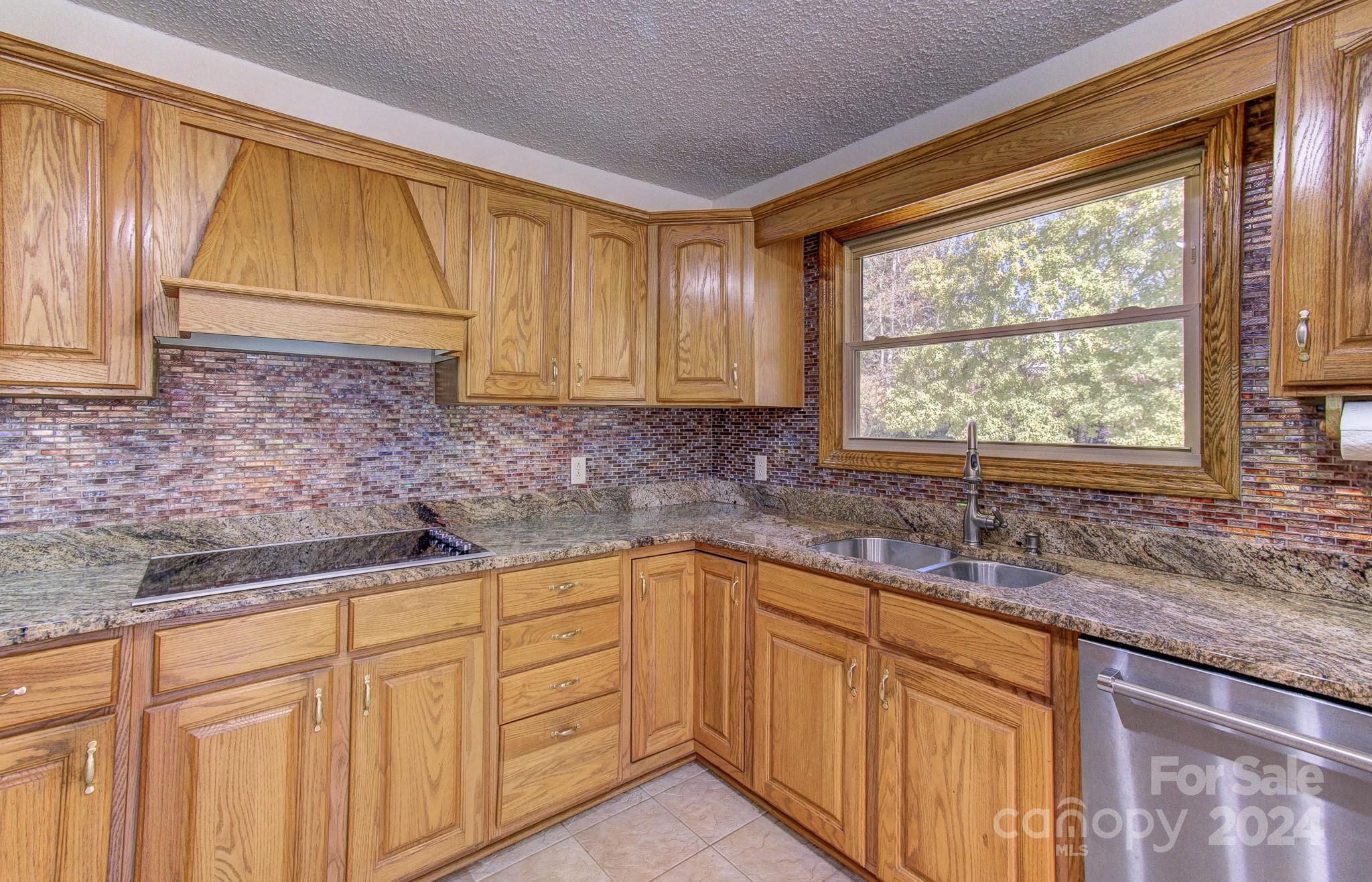 111 Souther Road Fletcher, NC 28732 - Photo 7 of 31 a kitchen with stainless steel appliances granite countertop white cabinets sink and a granite counter top