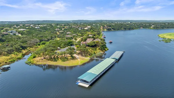an aerial view of a residential houses with outdoor space and swimming pool