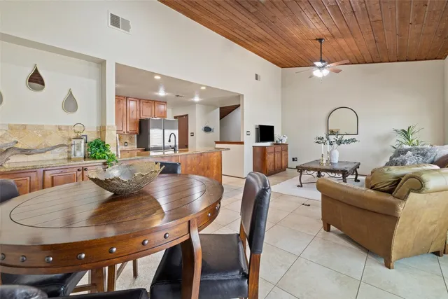 a view of a dining room with furniture and a window