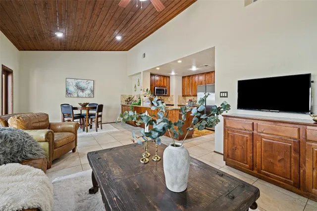 a living room with furniture a rug and a chandelier