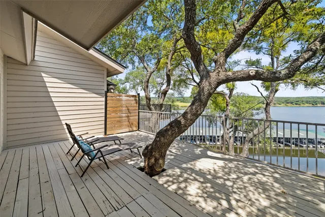 a view of balcony with wooden floor and fence