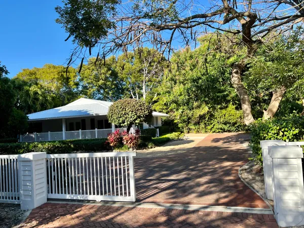 a bedroom with a bed and large mirror on the dresser