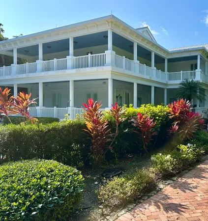a spacious bathroom with a granite countertop sink a toilet a mirror and shower