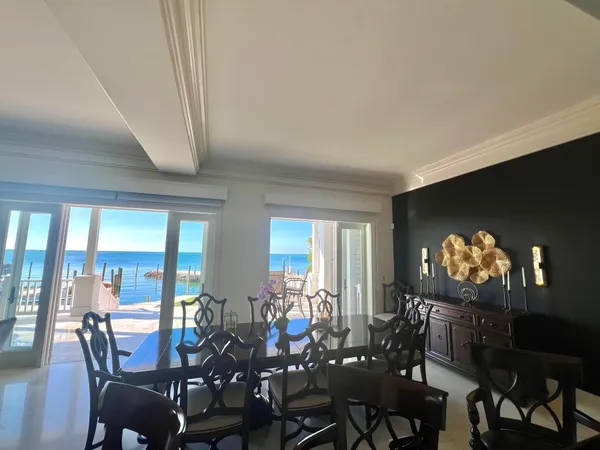 a bathroom with a granite countertop sink mirror toilet and next to a window