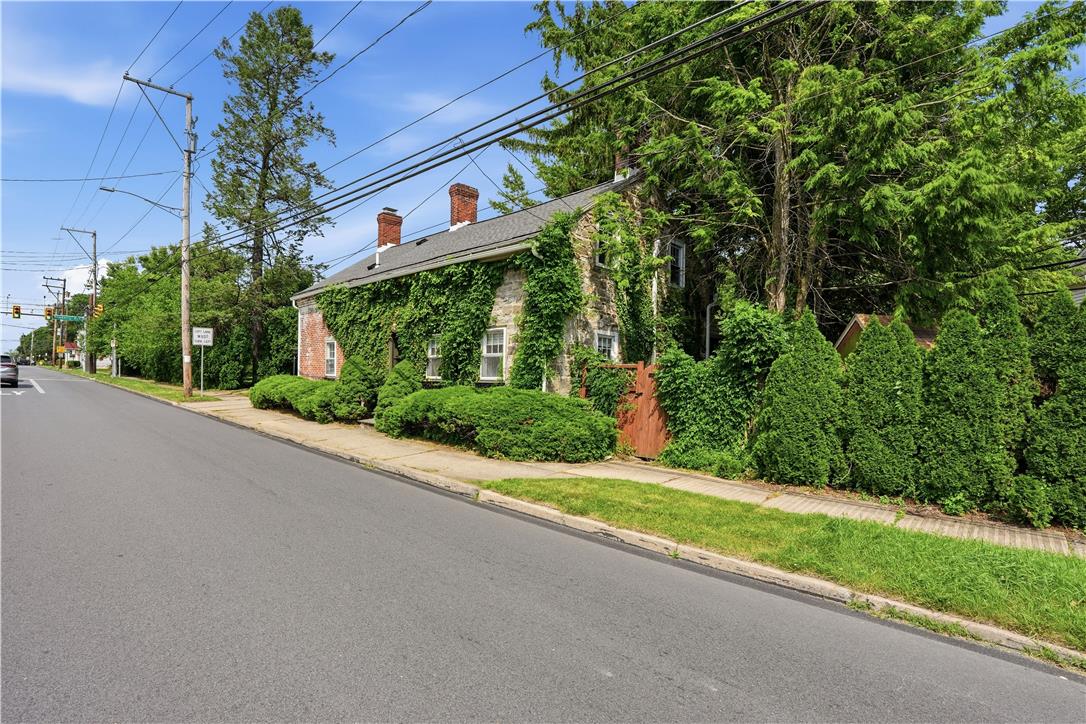 2014 Linden Street Bethlehem, PA 18017 - Photo 78 of 85 A stone-clad home with charming brick accents and lush, climbing greenery offers serene street-side appeal.