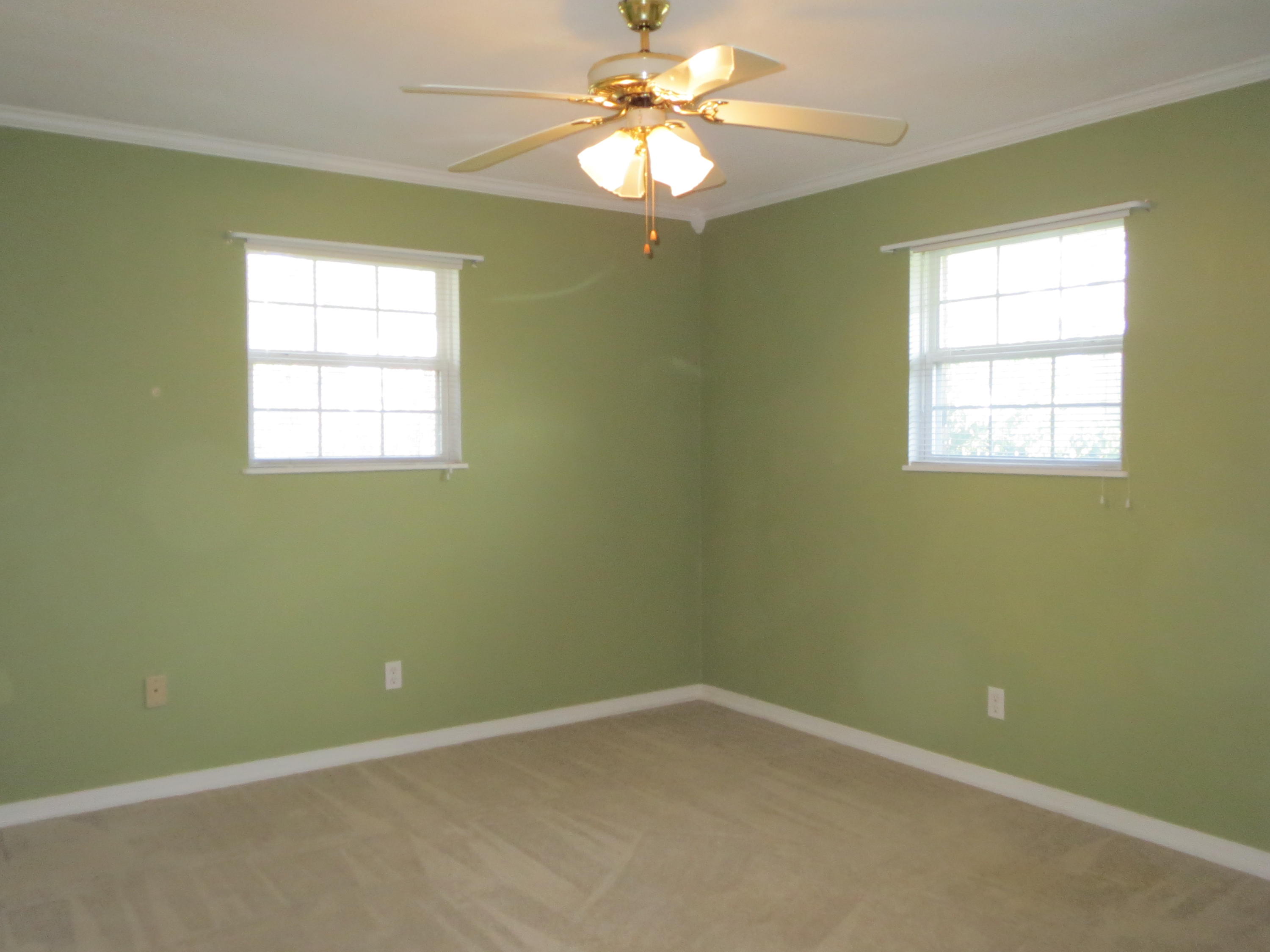 932 Tri County Road Graceville, FL 32440 - Photo 13 of 40 an empty room with a window and a fan