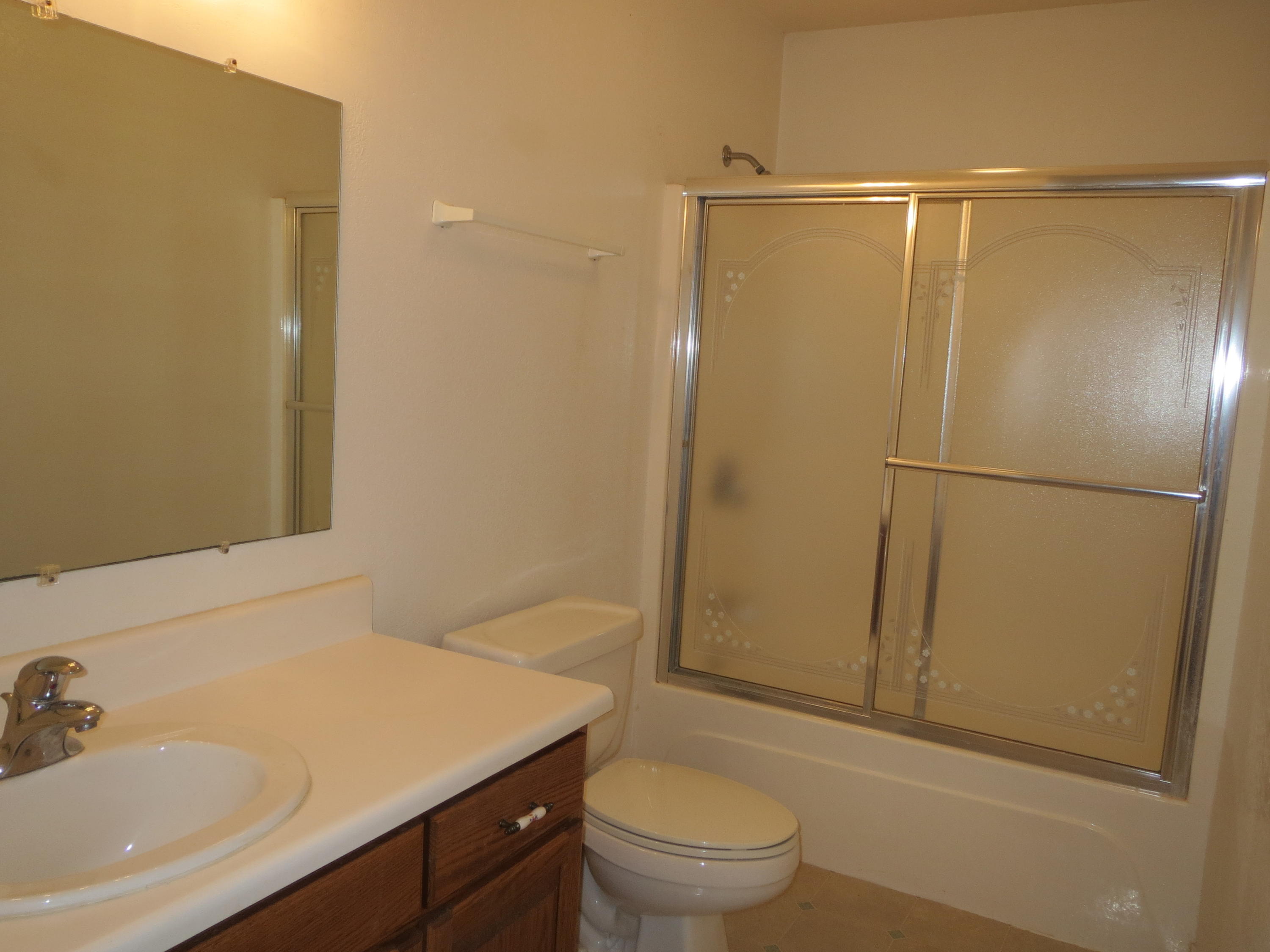 932 Tri County Road Graceville, FL 32440 - Photo 14 of 40 a bathroom with a granite countertop sink toilet and shower