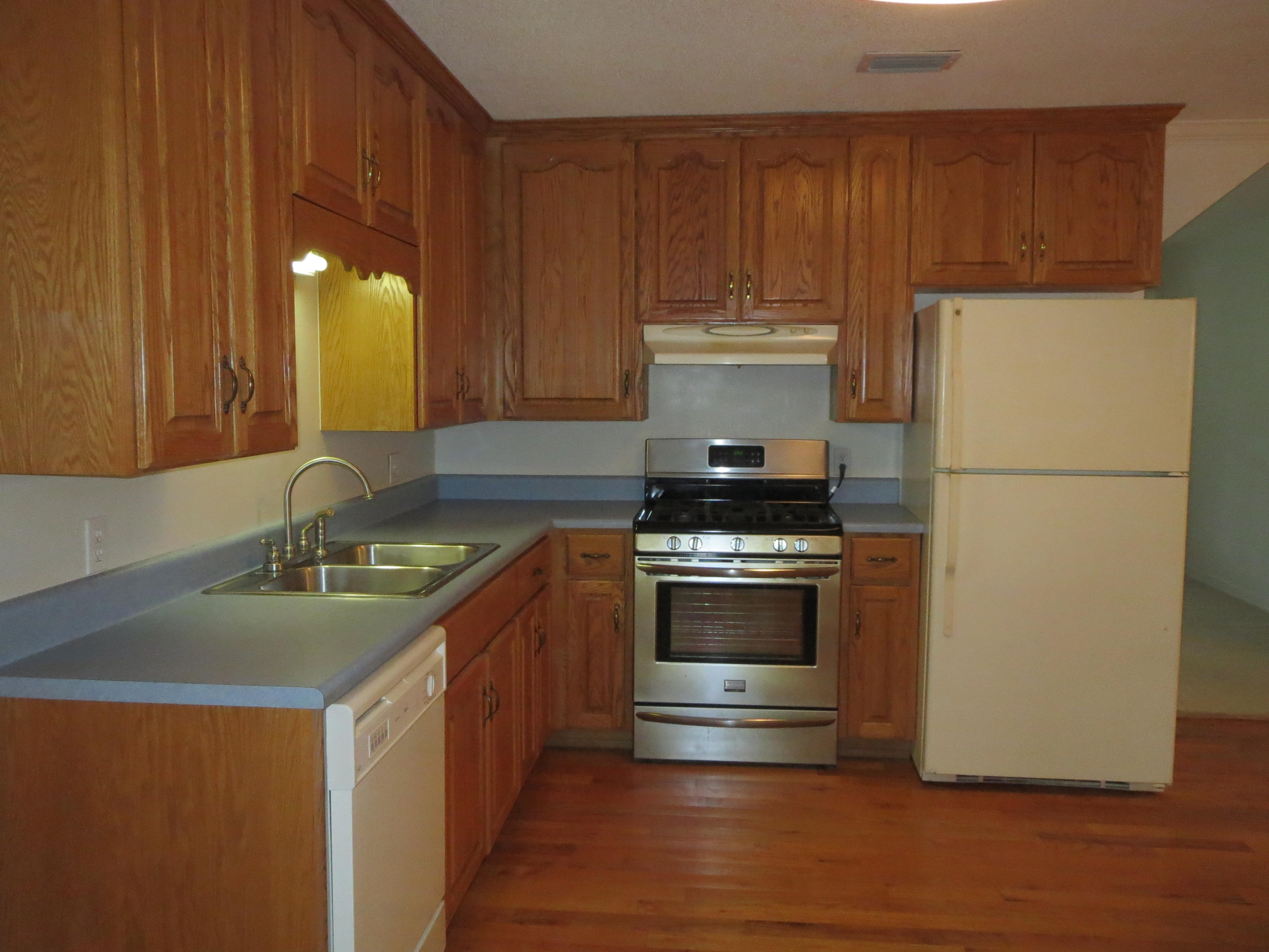 932 Tri County Road Graceville, FL 32440 - Photo 3 of 40 a kitchen with a refrigerator and a sink