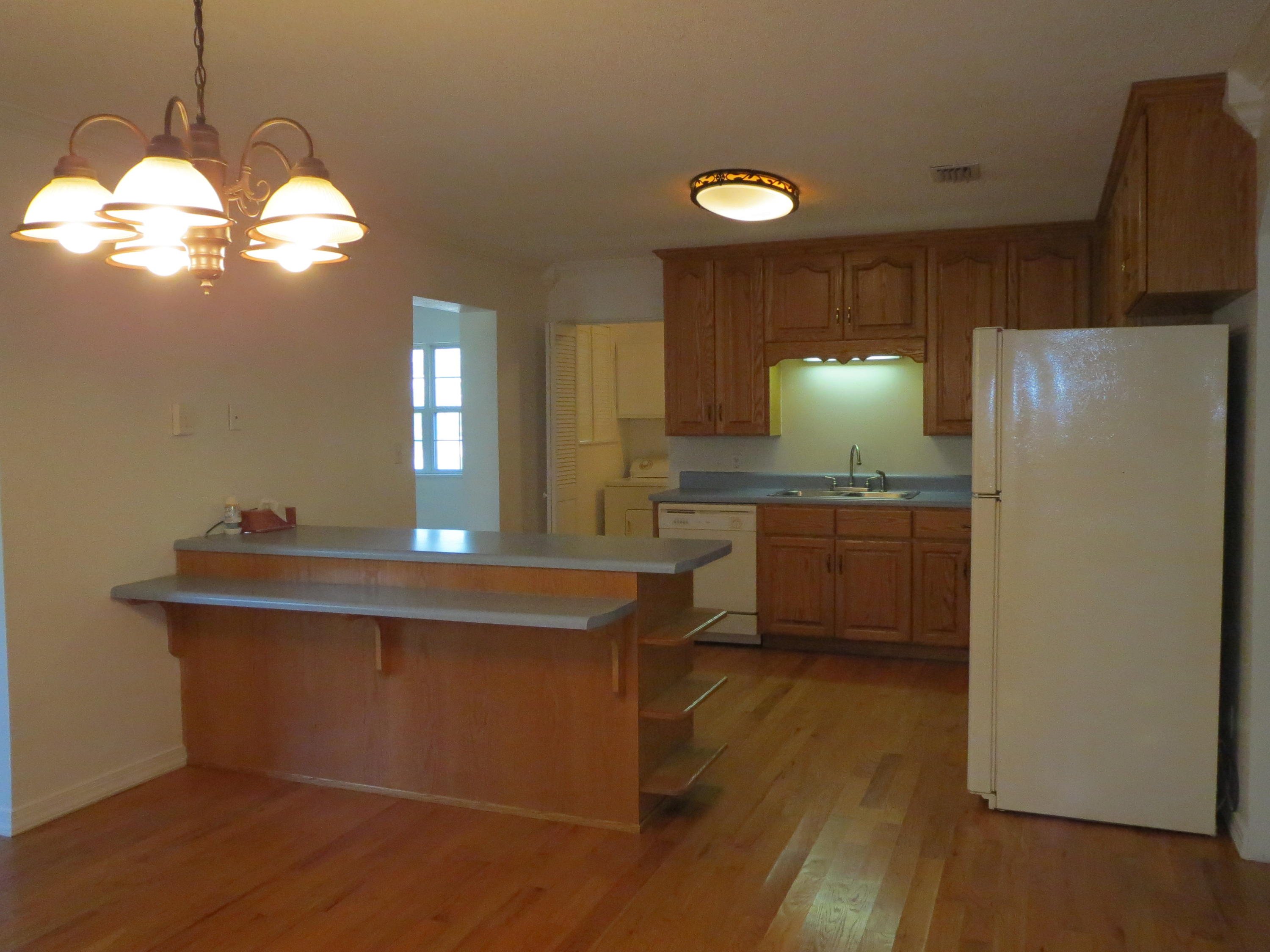 932 Tri County Road Graceville, FL 32440 - Photo 4 of 40 a kitchen with kitchen island a sink appliances a counter space and a window