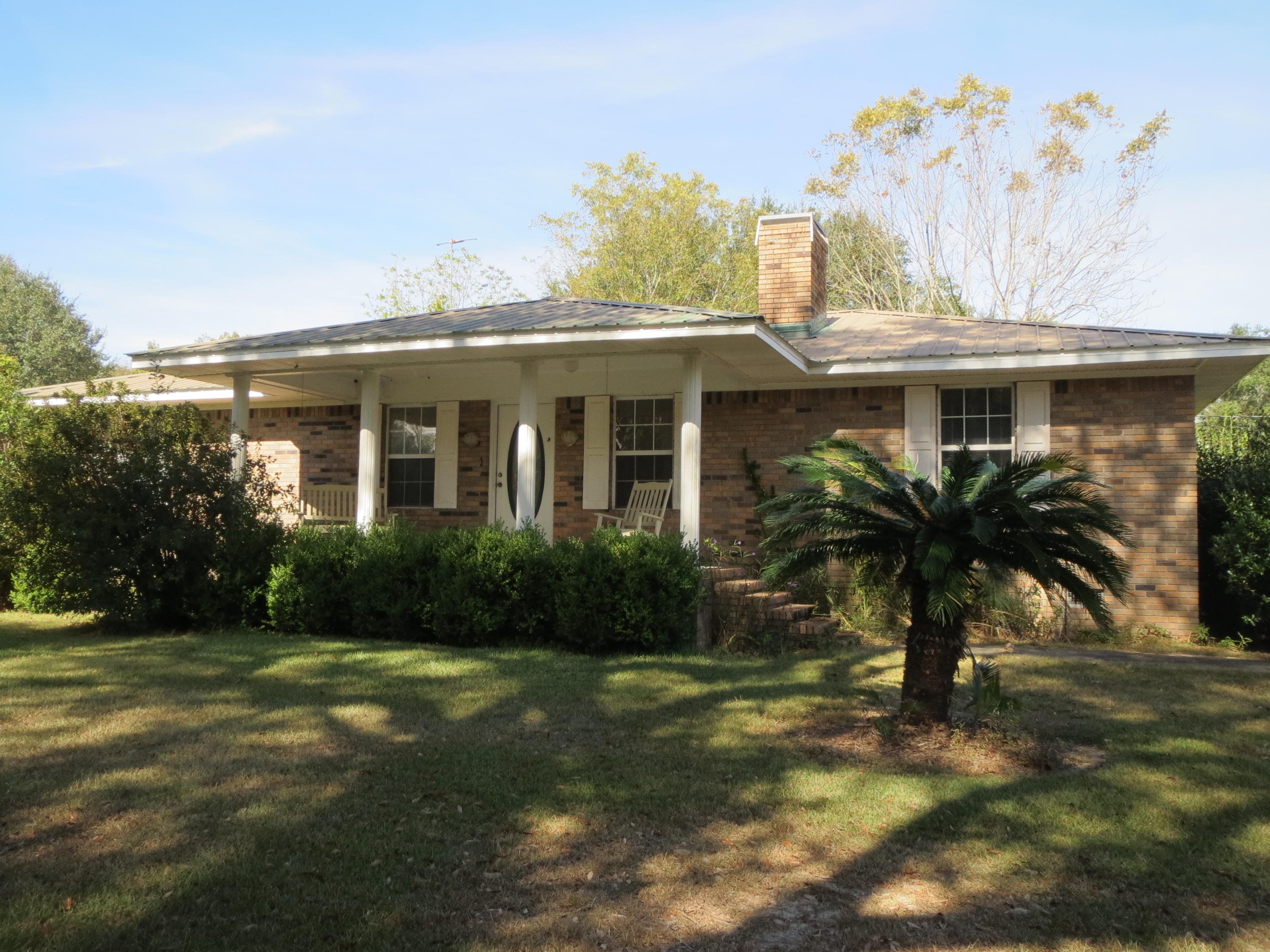 932 Tri County Road Graceville, FL 32440 - Photo 39 of 40 a front view of a house with garden