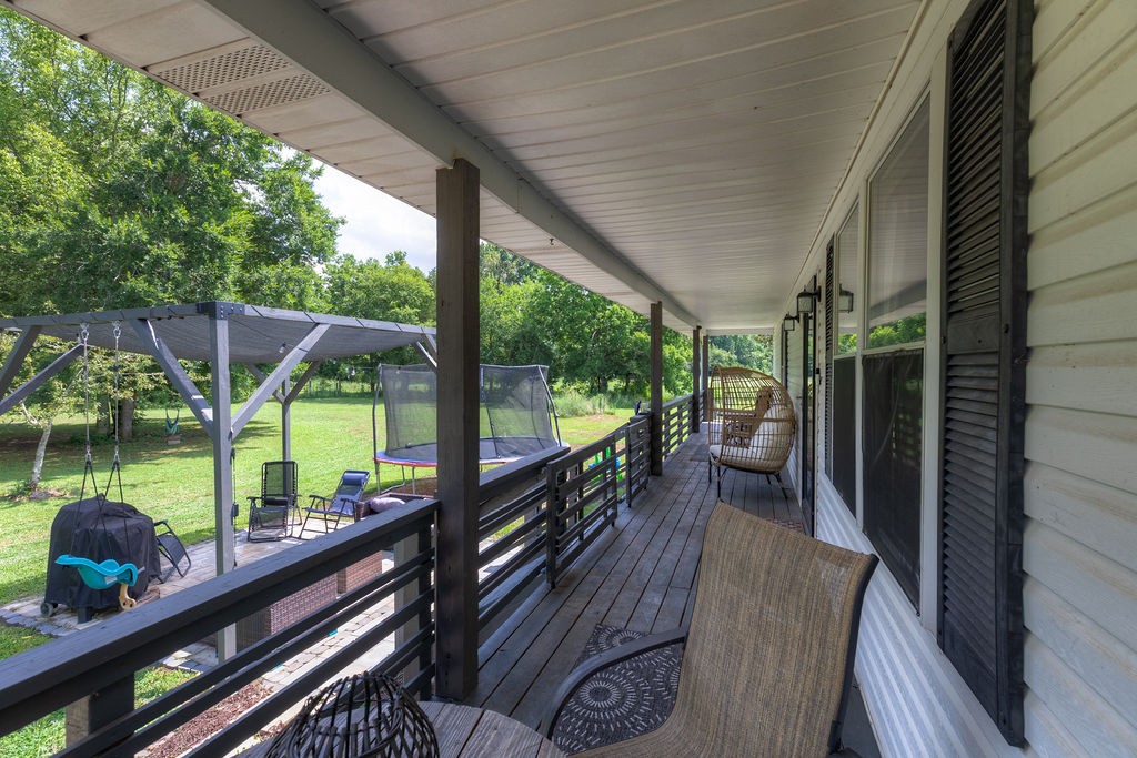 4580 Simmons Bluff Road Lebanon, TN 37090 - Photo 18 of 49 a view of a balcony with chairs and wooden floor