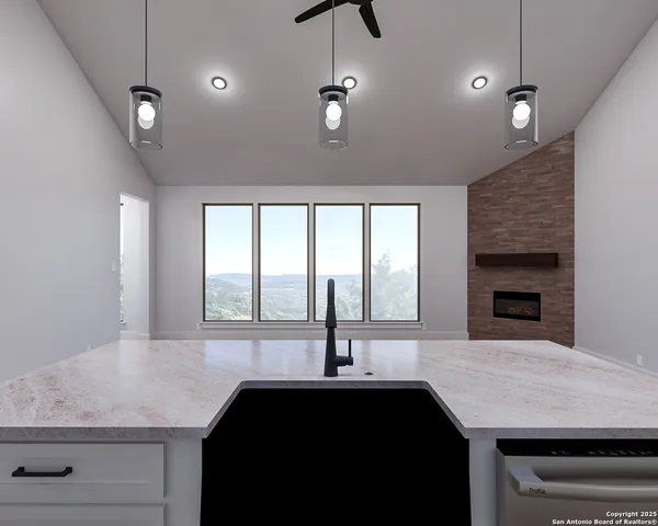 a kitchen with a sink a counter space and a window