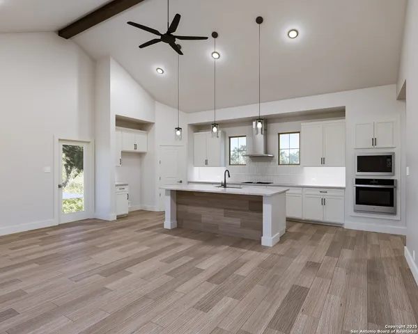 a large kitchen with kitchen island a sink stainless steel appliances and cabinets